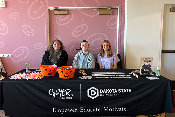 Catherine Hoier (left) is pictured with fellow CybHER volunteer Mikaila Fluth (center), and Paige Phinney (right).